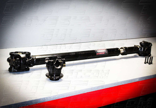 Front view of a Jeep JT Gladiator driveshaft, featuring a black steel tube, solid cross U-joints, and pinion flange.